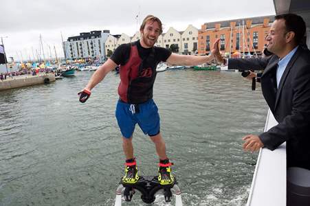 Taoiseach Leo Varadkar getting a high 5 from PowerFly’s world champion flyboarders swirling in the air on pump-powered jet packs in the heart of the harbour. Photo Andrew Downes, XPOSURE
